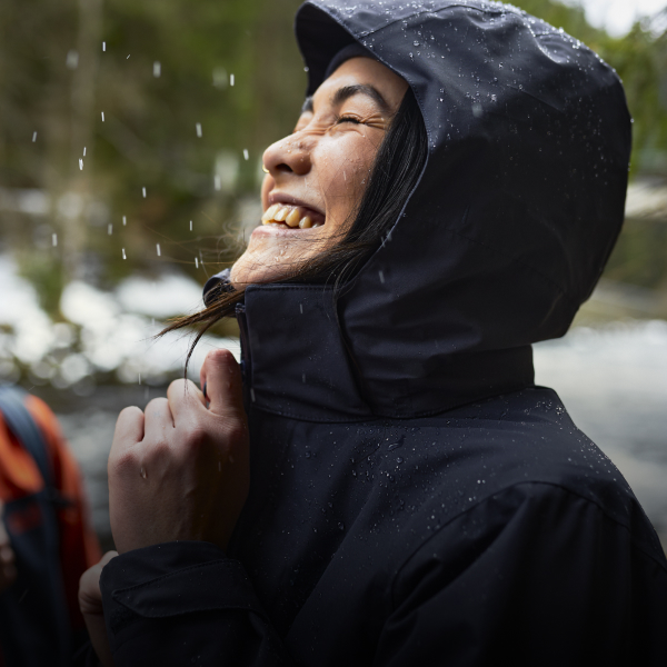 Vrouw met waterdicht jack in de regen